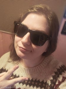 Maria wearing Meta Ray-ban smart glasses and posing with a peace sign.